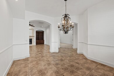 Unfurnished dining area with a chandelier, a fire