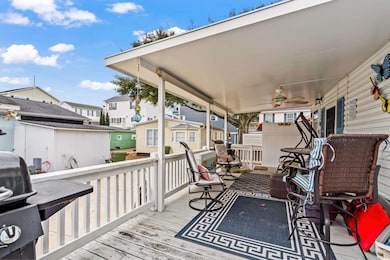 Deck featuring ceiling fan, a grill, and covered p