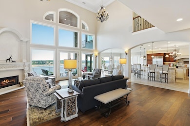 Living area with a chandelier, arched walkways, d