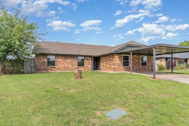 Ranch-style house featuring brick siding, concrete driveway, an attached carport, and roof with shingles