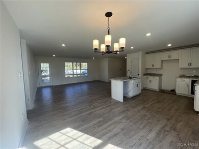 Kitchen featuring open floor plan, a chandelier, w