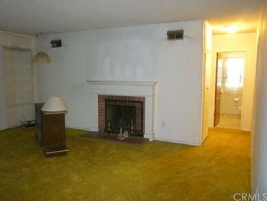 Fireplace in living room, full bathroom to right
