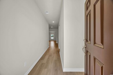 Hall with baseboards, visible vents, recessed ligh
