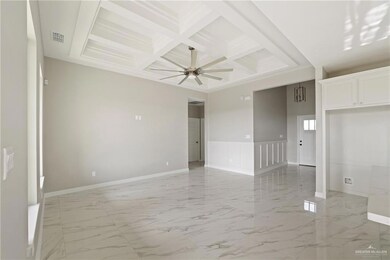 Spare room featuring coffered ceiling, beamed ceiling, light marble finish flooring, ceiling fan, and baseboards