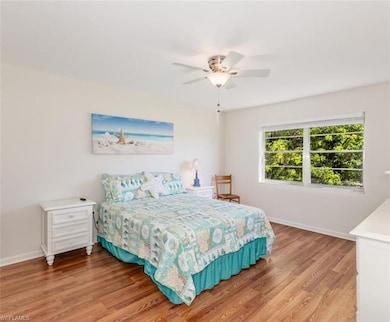 Bedroom with light wood-style flooring and a ceiling fan