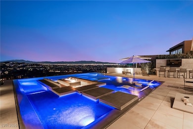 Pool at dusk featuring an in-ground hot tub, a bar