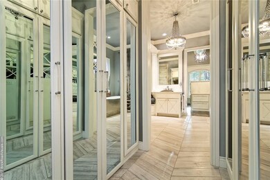 Behind those mirrored doors are custom vanities and built-ins. Sensored lights turn on when opened.