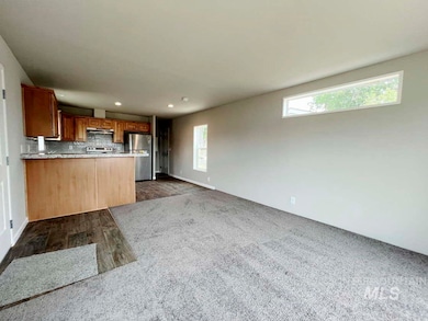 Kitchen with freestanding refrigerator, plenty of natural light, white electric stove, decorative backsplash, and recessed lighting