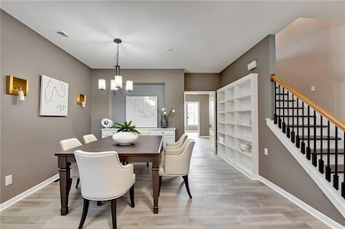Virtually staged dining space featuring built in shelving