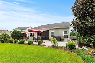 Back of house with a yard and a patio area