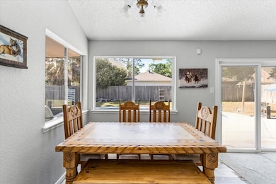 Dining area with views of the backyard and open to