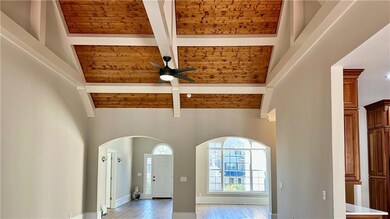 Sunlit family room with beautiful beams and cozy character.