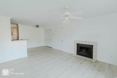 Unfurnished living room featuring ceiling fan, lig