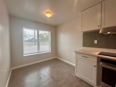 Kitchen with oven, under cabinet range hood, blac