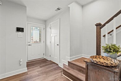 Entryway. Door to right is a 1st floor powder room