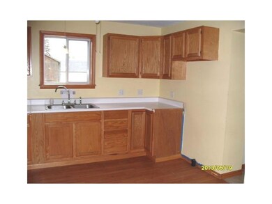 Kitchen. The kitchen features newer oak cabinetry 