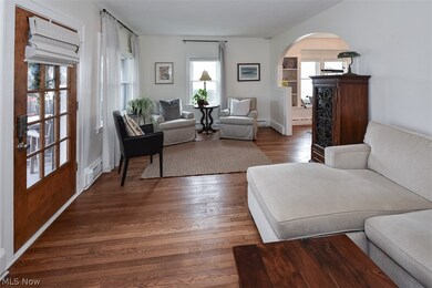 Living room featuring a baseboard radiator and dark wood-type flooring