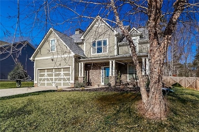 Craftsman inspired home with driveway, covered porch, brick siding, and a chimney