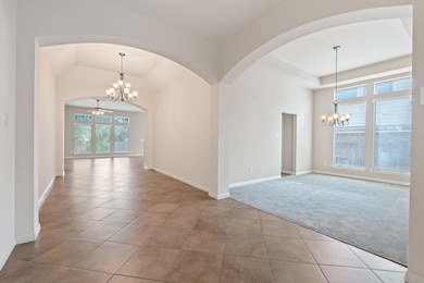 Unfurnished room with a chandelier, arched walkwa
