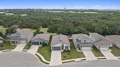 Aerial view of residential area featuring a forest