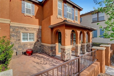 Property entrance with stucco siding and stone sid