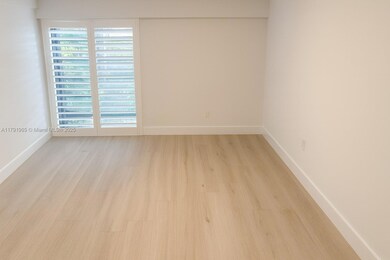 Master bedoom with floor to ceiling windows and plantation shutters.