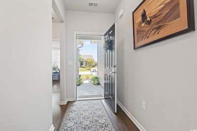 Foyer entrance with dark wood finished floors and baseboards