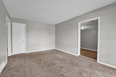 Spare room featuring baseboards, carpet floors, a 