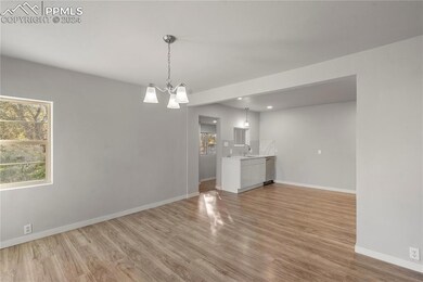 Unfurnished living room with a chandelier, sink, a