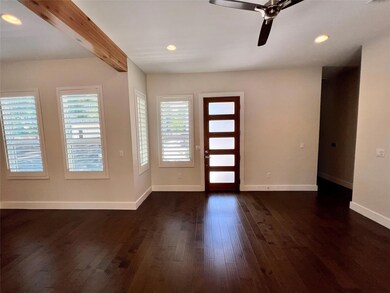 Foyer featuring dark wood-style flooring, baseboa