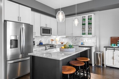 Bright kitchen with island & marble backsplash