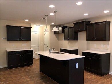 Espresso Kitchen cabinets by Marsh and quartz coun
