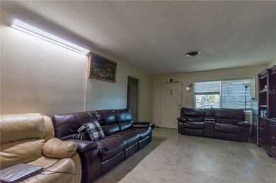 Living room with view of entry into bedroom area. 
