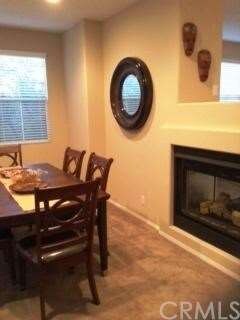 Dining room  shares the dual fireplace with the fa