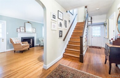 View from entry foyer of grand center hallway, living room and staircase