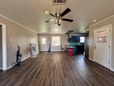 Unfurnished living room featuring ornamental moldi