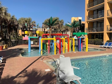 View of swimming pool with a playground