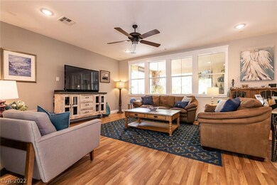 Cosy living room w/wood flooring & fan