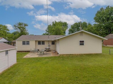 View of back patio, backyard, and back of 6 car ta