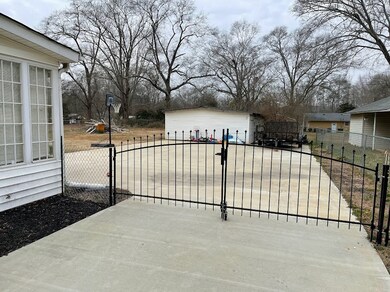 Fenced yard and large workshop and/or storage buil