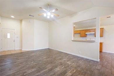 Unfurnished living room with dark wood finished f