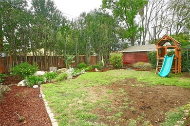 The backyard will be a favorite entertainment destination with its green lawn, large covered porch and colorful flowerbeds.