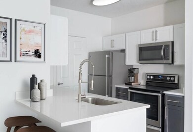 Kitchen with stainless steel appliances, a peninsu