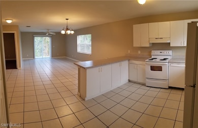 ENTRANCE LOOKING AT KITCHEN (RIGHT)  DINING & LIVING ROOM (CENTER)