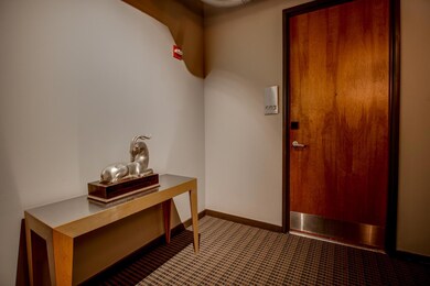 Hallway featuring dark colored carpet