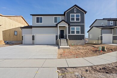 View of front facade featuring driveway, board and batten siding, and a garage