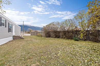 Spacious yard with mountain views and a wooden privacy fence