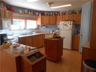 Open kitchen with island and all appliance remain.