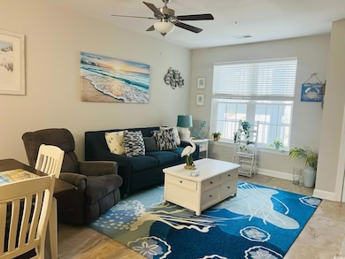 Living area with tile patterned flooring and a ceiling fan