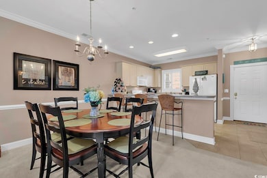 Tiled dining space with crown molding